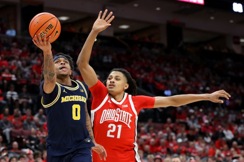 Mar 3, 2024; Columbus, Ohio, USA; Michigan Wolverines guard Dug McDaniel (0) looks to score as Ohio State Buckeyes forward Devin Royal (21) defends during the first half at Value City Arena. Mandatory Credit: Joseph Maiorana-USA TODAY Sports