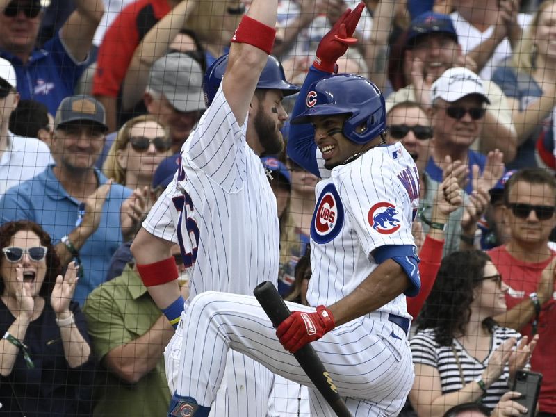 Sep 24, 2023; Chicago, Illinois, USA;  Chicago Cubs second baseman Christopher Morel (5), right, high fives Chicago Cubs third baseman Patrick Wisdom (16) after his two run home run against the Colorado Rockies during the sixth inning at Wrigley Field. Mandatory Credit: Matt Marton-USA TODAY Sports