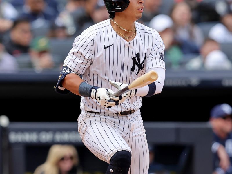 Apr 21, 2024; Bronx, New York, USA; New York Yankees third baseman Oswaldo Cabrera (95) follows through on an RBI single against the Tampa Bay Rays during the fifth inning at Yankee Stadium. Mandatory Credit: Brad Penner-USA TODAY Sports