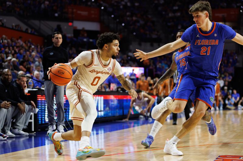 Jan 18, 2025; Gainesville, Florida, USA; Texas Longhorns guard Jordan Pope (0) dribbles the ball at Florida Gators forward Alex Condon (21) during the first half at Exactech Arena at the Stephen C. O'Connell Center. Mandatory Credit: Matt Pendleton-Imagn Images