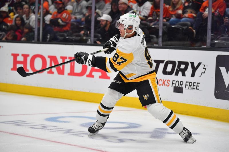 Oct 14, 2025; Anaheim, California, USA; Pittsburgh Penguins center Sidney Crosby (87) passes the puck against the Anaheim Ducks during the third period at Honda Center. Mandatory Credit: Gary A. Vasquez-Imagn Images