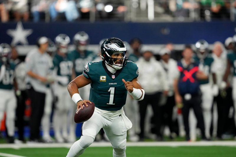 Philadelphia Eagles quarterback Jalen Hurts scrambles out of the pocket in the first half of an NFL football game against the Dallas Cowboys in Arlington, Texas, Sunday, Nov. 10, 2024. (AP Photo/Jeffrey McWhorter)