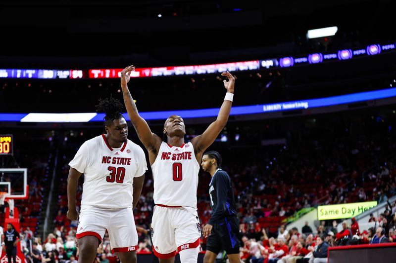 Dec 20, 2023; Raleigh, North Carolina, USA; North Carolina State Wolfpack guard DJ Horne (0) scores a three pointer and reacts with forward DJ Burns Jr. (30) during the second half against Saint Louis Billikens at PNC Arena. Mandatory Credit: Jaylynn Nash-USA TODAY Sports