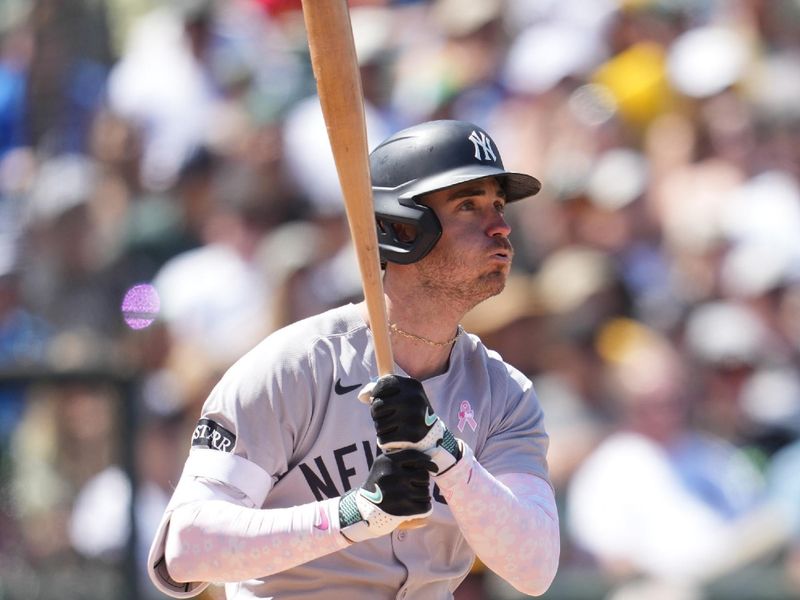 May 11, 2025; West Sacramento, California, USA; New York Yankees center fielder Cody Bellinger (35) hits a single against the Athletics in the fifth inning at Sutter Health Park. Mandatory Credit: Cary Edmondson-Imagn Images