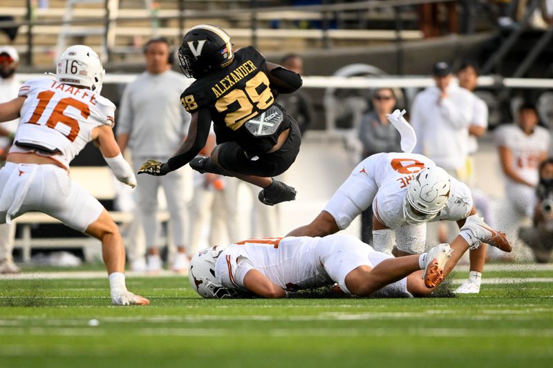 Oct 26, 2024; Nashville, Tennessee, USA; Texas Longhorns linebacker Colin Simmons (11) tackles Vanderbilt Commodores running back Sedrick Alexander (28) during the first half at FirstBank Stadium. Mandatory Credit: Steve Roberts-Imagn Images