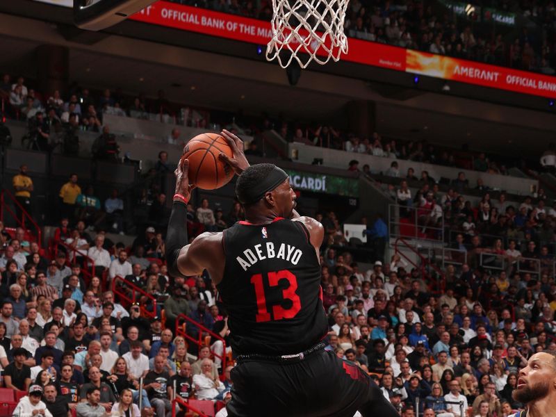 MIAMI, FL - MARCH 26:  Bam Adebayo #13 of the Miami Heat grabs a rebound during the game against the Golden State Warriors on March 26, 2024 at Kaseya Center in Miami, Florida. NOTE TO USER: User expressly acknowledges and agrees that, by downloading and or using this Photograph, user is consenting to the terms and conditions of the Getty Images License Agreement. Mandatory Copyright Notice: Copyright 2024 NBAE (Photo by Issac Baldizon/NBAE via Getty Images)