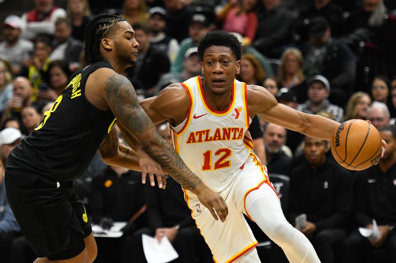 SALT LAKE CITY, UTAH - MARCH 15: De'Andre Hunter #12 of the Atlanta Hawks drives into Brice Sensabaugh #8 of the Utah Jazz during the first half of a game at Delta Center on March 15, 2024 in Salt Lake City, Utah.  NOTE TO USER: User expressly acknowledges and agrees that, by downloading and or using this photograph, User is consenting to the terms and conditions of the Getty Images License Agreement.  (Photo by Alex Goodlett/Getty Images)