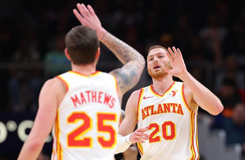 ATLANTA, GEORGIA - MARCH 27:  Dylan Windler #20 of the Atlanta Hawks reacts with Garrison Mathews #25 after hitting a three-point basket against the Portland Trail Blazers during the second quarter at State Farm Arena on March 27, 2024 in Atlanta, Georgia.  NOTE TO USER: User expressly acknowledges and agrees that, by downloading and/or using this photograph, user is consenting to the terms and conditions of the Getty Images License Agreement.  (Photo by Kevin C. Cox/Getty Images)