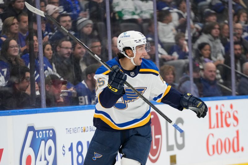 Oct 24, 2024; Toronto, Ontario, CAN; St. Louis Blues forward Jordan Kyrou (25) reacts after assisting on a goal by forward Alexandre Texier (not pictured) during the second period against the Toronto Maple Leafs at Scotiabank Arena. Mandatory Credit: John E. Sokolowski-Imagn Images