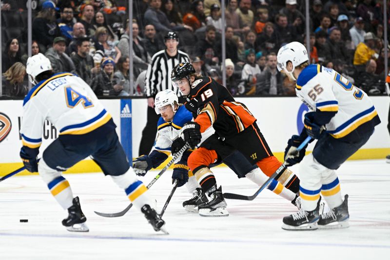 Mar 25, 2023; Anaheim, California, USA; Anaheim Ducks right wing Troy Terry (19) moves the puck while St. Louis Blues right wing Kasperi Kapanen (42) defends during first period at Honda Center. Mandatory Credit: Kelvin Kuo-USA TODAY Sports