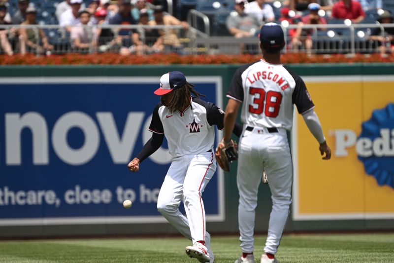 Jul 7, 2024; Washington, District of Columbia, USA; Washington Nationals center fielder James Wood (29) misplays a pop up in the outfield in front of third baseman Trey Lipscomb (38) against the St. Louis Cardinals during the second inning at Nationals Park. Mandatory Credit: Rafael Suanes-USA TODAY Sports