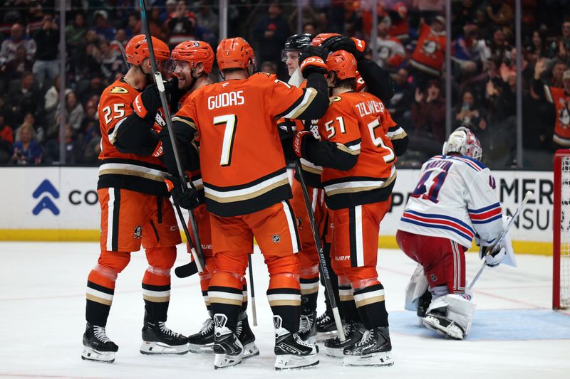 Jan 19, 2026; Anaheim, California, USA;  Anaheim Ducks left wing Jeffrey Viel (second from left) celebrates with Ryan Poehling (25) and Radko Gudas (7) and Olen Zellweger (51) after scoring a goal during the second period against the New York Rangers at Honda Center. Mandatory Credit: Kiyoshi Mio-Imagn Images
