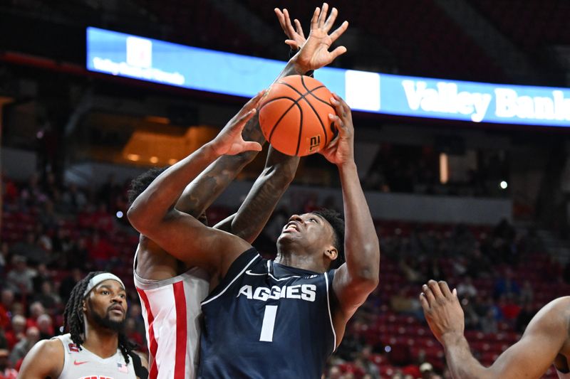 Jan 13, 2024; Las Vegas, Nevada, USA; Utah State Aggies forward Great Osobor (1) tries to score on UNLV Rebels forward Kalib Boone (10) in the second half at Thomas & Mack Center. Mandatory Credit: Candice Ward-USA TODAY Sports