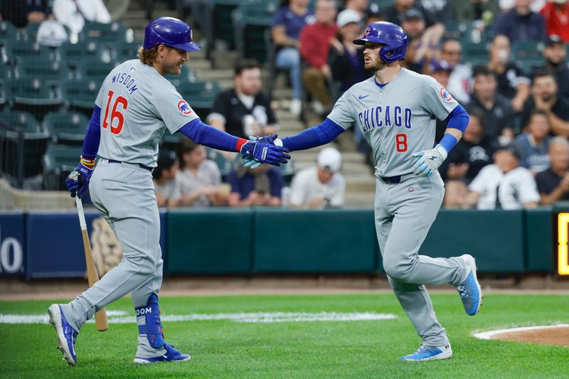 Aug 9, 2024; Chicago, Illinois, USA; Chicago Cubs outfielder Ian Happ (8) celebrates with first baseman Patrick Wisdom (16) after hitting a solo home run against the Chicago White Sox during the first inning at Guaranteed Rate Field. Mandatory Credit: Kamil Krzaczynski-USA TODAY Sports