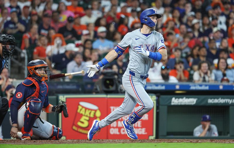 Apr 14, 2024; Houston, Texas, USA; Texas Rangers left fielder Evan Carter (32) hits a home run during the fourth inning against the Houston Astros at Minute Maid Park. Mandatory Credit: Troy Taormina-USA TODAY Sports