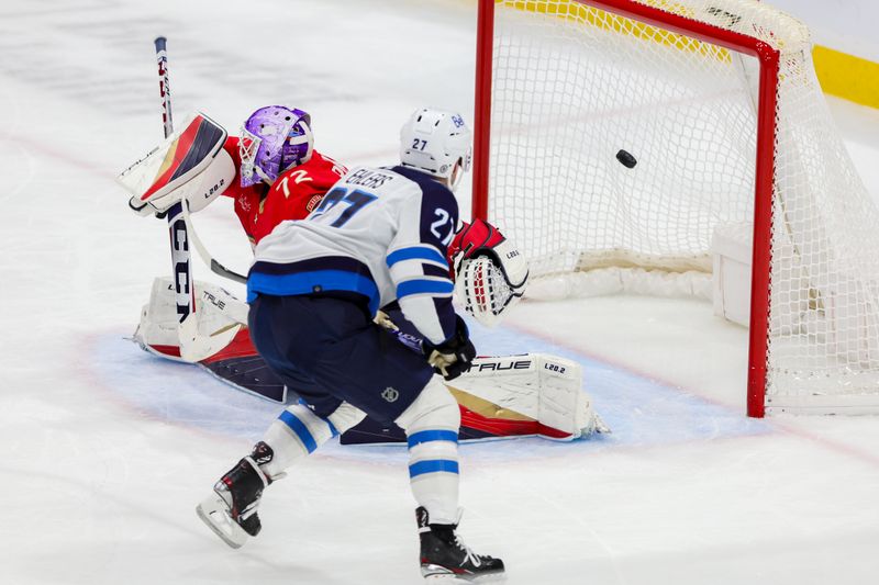 Nov 24, 2023; Sunrise, Florida, USA; Winnipeg Jets left wing Nikolaj Ehlers (27) scores against Florida Panthers goaltender Sergei Bobrovsky (72) during the third period at Amerant Bank Arena. Mandatory Credit: Sam Navarro-USA TODAY Sports