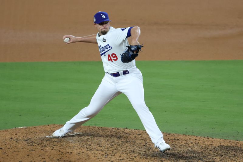 Oct 25, 2024; Los Angeles, California, USA; Los Angeles Dodgers pitcher Blake Treinen (49) pitches in the ninth inning against the New York Yankees during game one of the 2024 MLB World Series at Dodger Stadium. Mandatory Credit: Kiyoshi Mio-Imagn Images