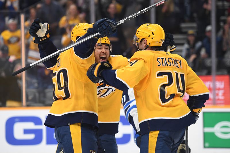 Apr 9, 2024; Nashville, Tennessee, USA; Nashville Predators defenseman Spencer Stastney (24) celebrates with left wing Kiefer Sherwood (44) and defenseman Roman Josi (59) during the third period against the Winnipeg Jets at Bridgestone Arena. Mandatory Credit: Christopher Hanewinckel-USA TODAY Sports