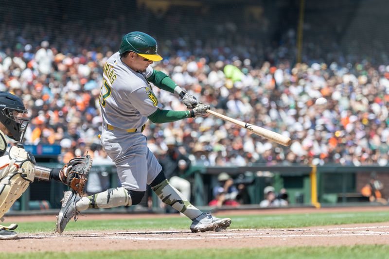May 18, 2025; San Francisco, California, USA; Oakland Athletics second base Luis Urías (17) doubles during the fourth inning against the San Francisco Giants at Oracle Park. Mandatory Credit: Bob Kupbens-Imagn Images