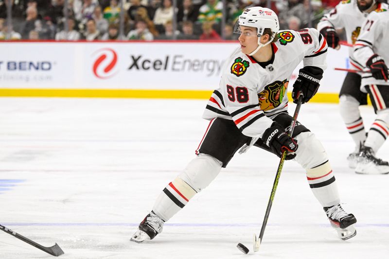 Nov 29, 2024; Saint Paul, Minnesota, USA;  Chicago Blackhawks forward Connor Bedard (98) controls the puck against the Minnesota Wild during the third period at Xcel Energy Center. Mandatory Credit: Nick Wosika-Imagn Images