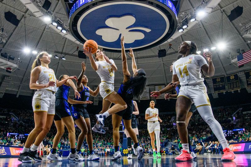 Feb 5, 2023; South Bend, Indiana, USA; Notre Dame Fighting Irish guard Sonia Citron (11) goes up for a shot as Duke Blue Devils guard Reigan Richardson (24) defends in the first half at the Purcell Pavilion. Mandatory Credit: Matt Cashore-USA TODAY Sports