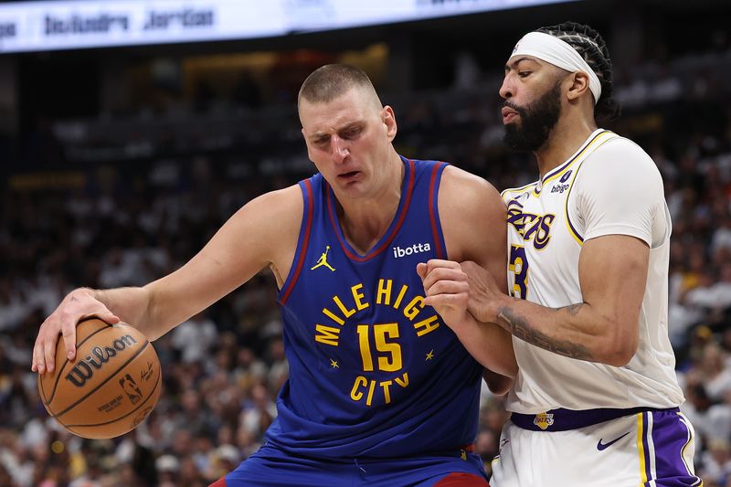 DENVER, COLORADO - APRIL 20: Nikola Jokic #15 of the Denver Nuggets drives against Anthony Davis #3 of the Los Angeles Lakers in the third quarter during game one of the Western Conference First Round Playoffs at Ball Arena on April 20, 2024 in Denver, Colorado.  NOTE TO USER: User expressly acknowledges and agrees that, by downloading and or using this photograph, User is consenting to the terms and conditions of the Getty Images License Agreement. (Photo by Matthew Stockman/Getty Images)