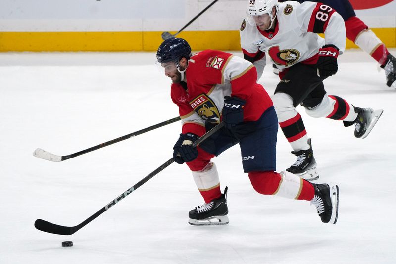 Oct 11, 2025; Sunrise, Florida, USA;  Florida Panthers center Luke Kunin (71) brings the puck up the ice as Ottawa Senators center Lars Eller (89) follows on the play during the third period at Amerant Bank Arena. Mandatory Credit: Jim Rassol-Imagn Images