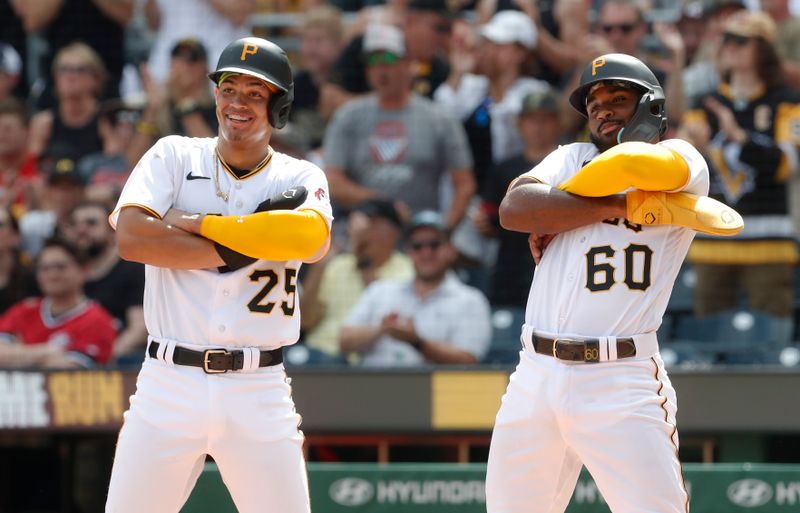 Aug 13, 2023; Pittsburgh, Pennsylvania, USA; Pittsburgh Pirates catcher Endy Rodriguez (25) and shortstop Liover Peguero (60) react as the wait for pinch hitter Jared Triolo (not pictured) at home plate after Triolo hit a three run home run to record his first major league home run against the Cincinnati Reds during the seventh inning at PNC Park. Mandatory Credit: Charles LeClaire-USA TODAY Sports