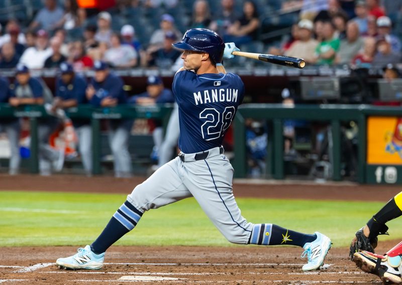 Apr 22, 2025; Phoenix, Arizona, USA; Tampa Bay Rays outfielder Jake Mangum hits an RBI single in the second inning against the Arizona Diamondbacks at Chase Field. Mandatory Credit: Mark J. Rebilas-Imagn Images