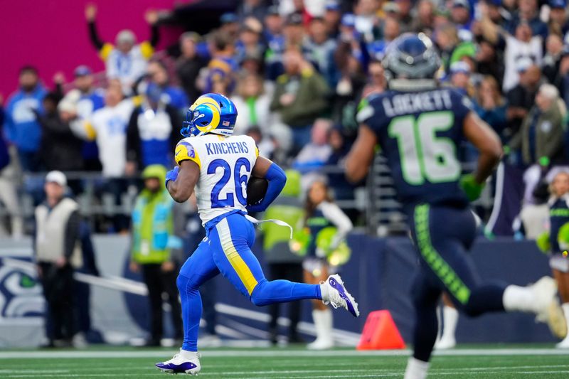 Los Angeles Rams safety Kamren Kinchens (26) returns an interception for a touchdown during the second half of an NFL football game against the Seattle Seahawks in Seattle, Sunday, Nov. 3, 2024. (AP Photo/Lindsey Wasson)