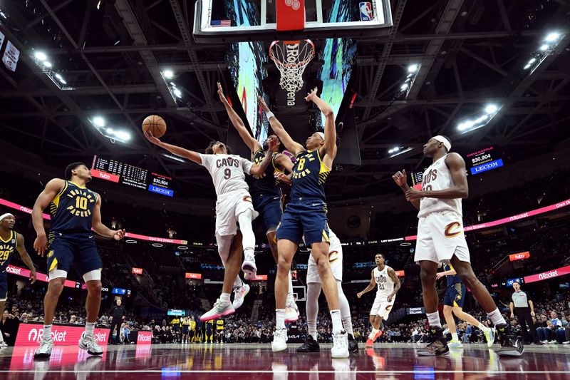 CLEVELAND, OHIO - APRIL 13: Craig Porter Jr. #9 of the Cleveland Cavaliers shoots over Tony Bradley #13 and Enrique Freeman #8 of the Indiana Pacers during overtime at Rocket Arena on April 13, 2025 in Cleveland, Ohio. The Pacers defeated the Cavaliers 126-118 in double overtime. NOTE TO USER: User expressly acknowledges and agrees that, by downloading and or using this photograph, User is consenting to the terms and conditions of the Getty Images License Agreement. (Photo by Jason Miller/Getty Images)