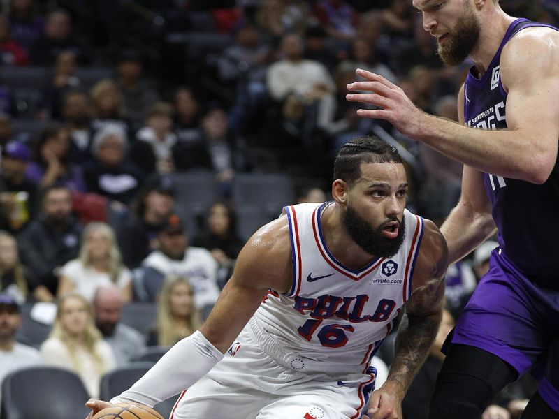 SACRAMENTO, CALIFORNIA - JANUARY 01: Caleb Martin #16 of the Philadelphia 76ers drives towards the basket on Domantas Sabonis #11 of the Sacramento Kings during the second half of an NBA basketball game at Golden 1 Center on January 01, 2025 in Sacramento, California. NOTE TO USER: User expressly acknowledges and agrees that, by downloading and or using this photograph, User is consenting to the terms and conditions of the Getty Images License Agreement. (Photo by Thearon W. Henderson/Getty Images)