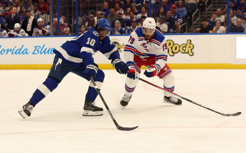 Mar 14, 2024; Tampa, Florida, USA; Tampa Bay Lightning left wing Anthony Duclair (10) skates with the puck as New York Rangers defenseman K'Andre Miller (79) defends during the third period at Amalie Arena. Mandatory Credit: Kim Klement Neitzel-USA TODAY Sports