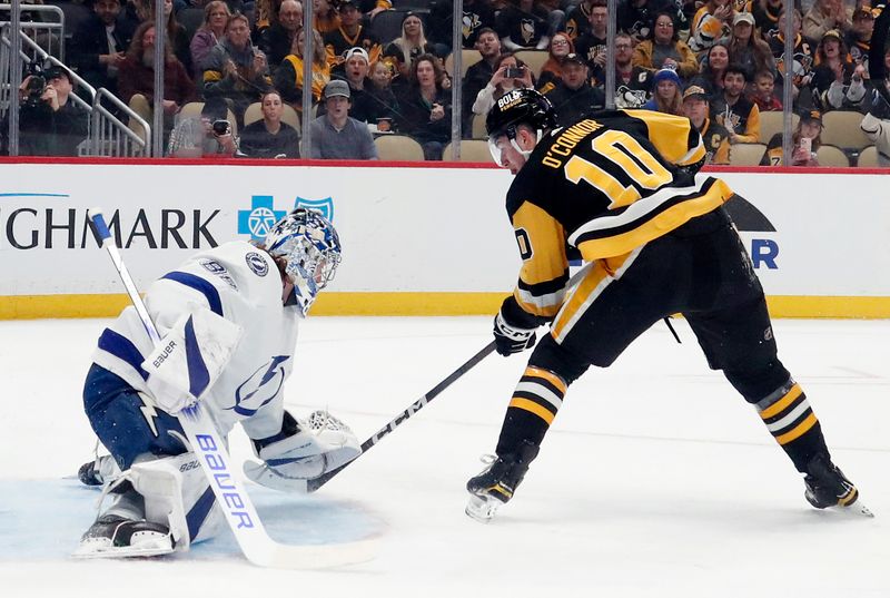 Apr 6, 2024; Pittsburgh, Pennsylvania, USA;  Tampa Bay Lightning goaltender Andrei Vasilevskiy (88) makes a save against Pittsburgh Penguins left wing Drew O'Connor (10) during the first period at PPG Paints Arena. Mandatory Credit: Charles LeClaire-USA TODAY Sports