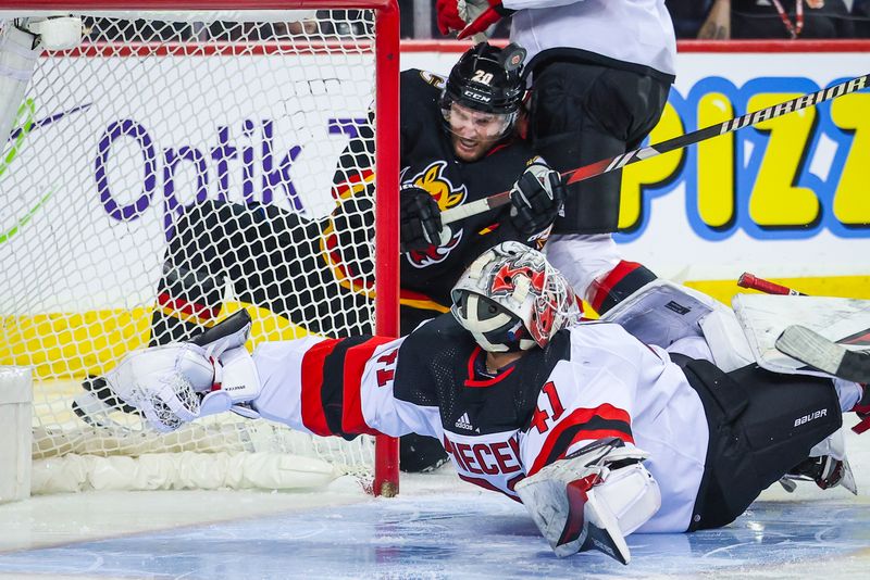 Dec 9, 2023; Calgary, Alberta, CAN; New Jersey Devils goaltender Vitek Vanecek (41) guards his net as Calgary Flames center Jonathan Huberdeau (10) tries to score during the second period at Scotiabank Saddledome. Mandatory Credit: Sergei Belski-USA TODAY Sports