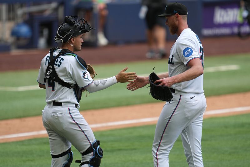 Apr 5, 2023; Miami, Florida, USA; Miami Marlins relief pitcher A.J. Puk (35) is congratulated by catcher Nick Fortes (4) following a 5-2 victory over the Minnesota Twins at loanDepot Park. Mandatory Credit: Jim Rassol-USA TODAY Sports