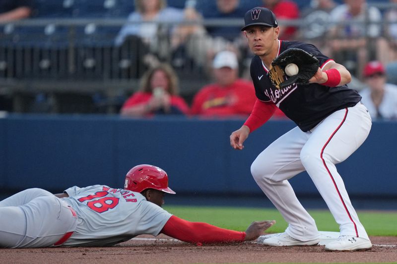 Mar 8, 2024; West Palm Beach, Florida, USA; St. Louis Cardinals right fielder Jordan Walker (18) dives back to first base as Washington Nationals first baseman Joey Meneses (45) catches the ball at CACTI Park of the Palm Beaches. Mandatory Credit: Jim Rassol-USA TODAY Sports