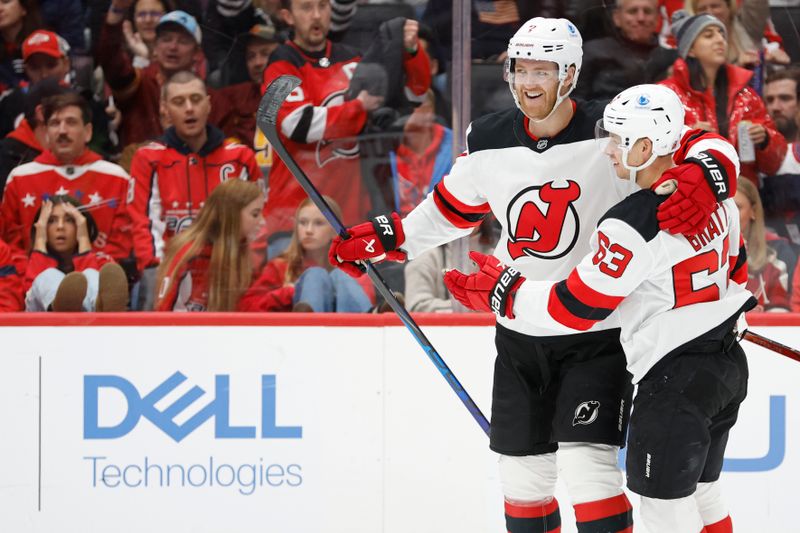 Nov 23, 2024; Washington, District of Columbia, USA; New Jersey Devils defenseman Dougie Hamilton (7) celebrates with Devils left wing Jesper Bratt (63) after scoring a goal against the Washington Capitals in the second period at Capital One Arena. Mandatory Credit: Geoff Burke-Imagn Images