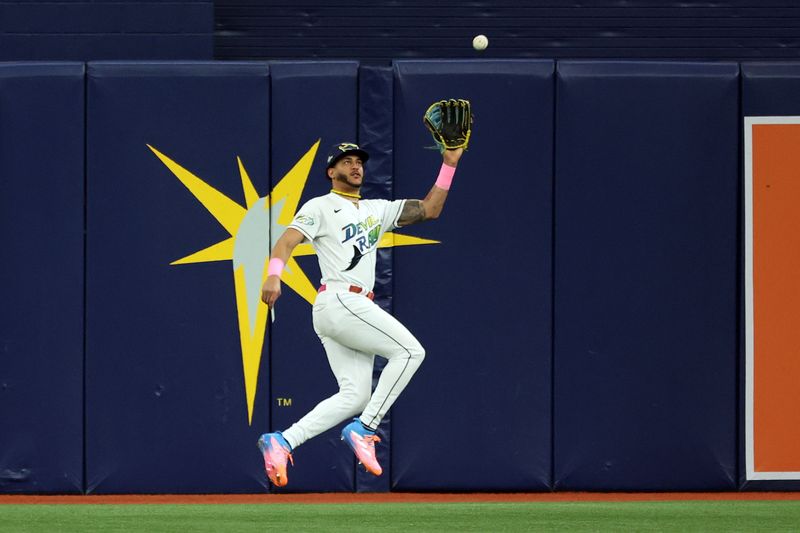 Oct 3, 2023; St. Petersburg, Florida, USA; Tampa Bay Rays center fielder Jose Siri (22) makes a catch on a fly ball hit by Texas Rangers third baseman Josh Jung (6) in the fourth inning during game one of the Wildcard series for the 2023 MLB playoffs at Tropicana Field. Mandatory Credit: Kim Klement Neitzel-USA TODAY Sports