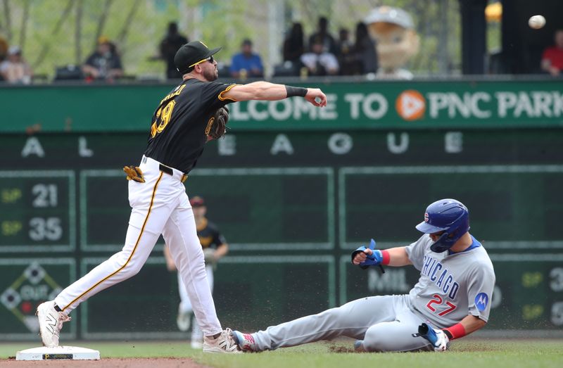 May 1, 2025; Pittsburgh, Pennsylvania, USA;  Pittsburgh Pirates second baseman Jared Triolo (19) throws to first base to complete a double play over Chicago Cubs designated hitter Seiya Suzuki (27) during the third inning at PNC Park. Mandatory Credit: Charles LeClaire-Imagn Images