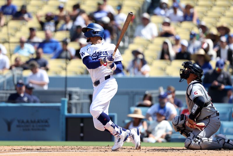 Sep 8, 2024; Los Angeles, California, USA;  Los Angeles Dodgers right fielder Mookie Betts (50) hits a triple during the fourth inning against the Cleveland Guardians at Dodger Stadium. Mandatory Credit: Kiyoshi Mio-Imagn Images