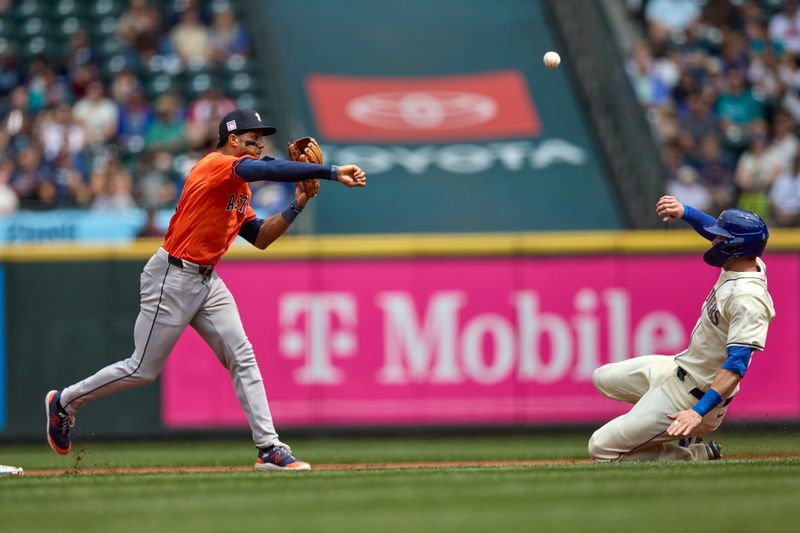 Jul 21, 2024; Seattle, Washington, USA; Seattle Mariners designated hitter Mitch Haniger (17) is forced out at second as Houston Astros shortstop Jeremy Peña (3) makes a throw to first in a double play attempt during the second inning at T-Mobile Park. Mandatory Credit: John Froschauer-USA TODAY Sports