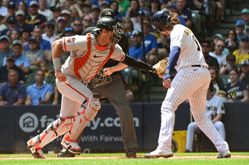 May 28, 2023; Milwaukee, Wisconsin, USA; San Francisco Giants catcher Blake Sabol (2) tags out Milwaukee Brewers third baseman Brian Anderson (9) trying to score in the first inning at American Family Field. Mandatory Credit: Benny Sieu-USA TODAY Sports