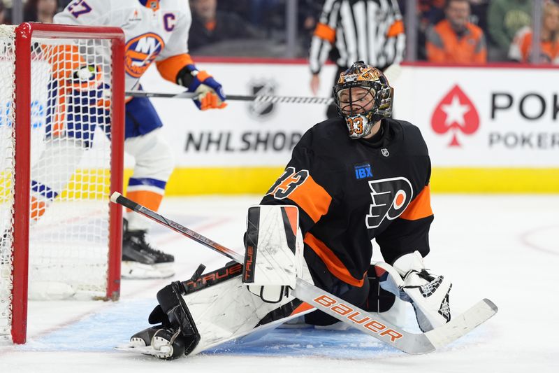 Apr 12, 2025; Philadelphia, Pennsylvania, USA; Philadelphia Flyers goalie Samuel Ersson (33) makes a save against the New York Islanders in the third period at Wells Fargo Center. Mandatory Credit: Kyle Ross-Imagn Images