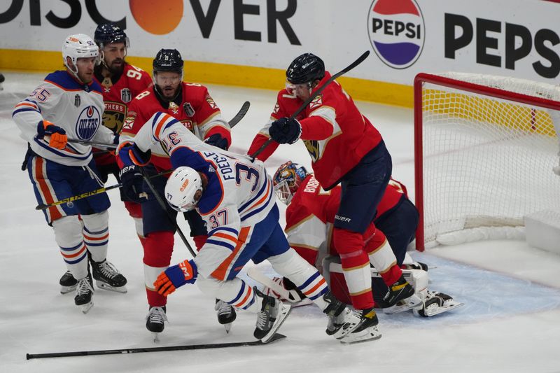 Jun 24, 2024; Sunrise, Florida, USA; Florida Panthers forward Evan Rodrigues (17) checks Edmonton Oilers forward Warren Foegele (37) during the first period in game seven of the 2024 Stanley Cup Final at Amerant Bank Arena. Mandatory Credit: Jim Rassol-USA TODAY Sports