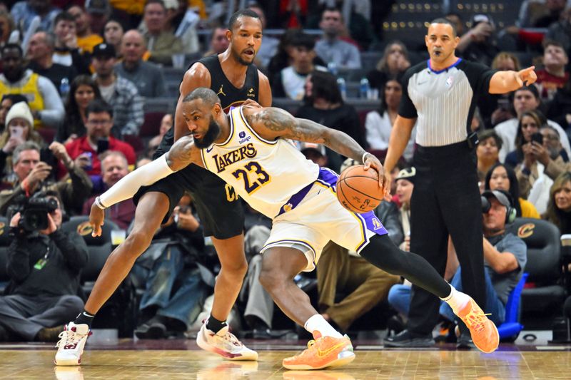 CLEVELAND, OHIO - NOVEMBER 25: LeBron James #23 of the Los Angeles Lakers drives to the basket around Evan Mobley #4 of the Cleveland Cavaliers during the fourth quarter at Rocket Mortgage Fieldhouse on November 25, 2023 in Cleveland, Ohio. The Lakers defeated the Cavaliers 121-115. NOTE TO USER: User expressly acknowledges and agrees that, by downloading and or using this photograph, User is consenting to the terms and conditions of the Getty Images License Agreement. (Photo by Jason Miller/Getty Images)