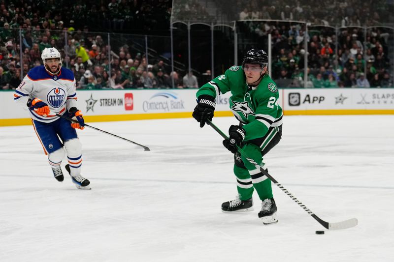 Feb 17, 2024; Dallas, Texas, USA;  Dallas Stars center Roope Hintz (24) passes the puck against Edmonton Oilers left wing Evander Kane (91) during the second period at American Airlines Center. Mandatory Credit: Chris Jones-USA TODAY Sports