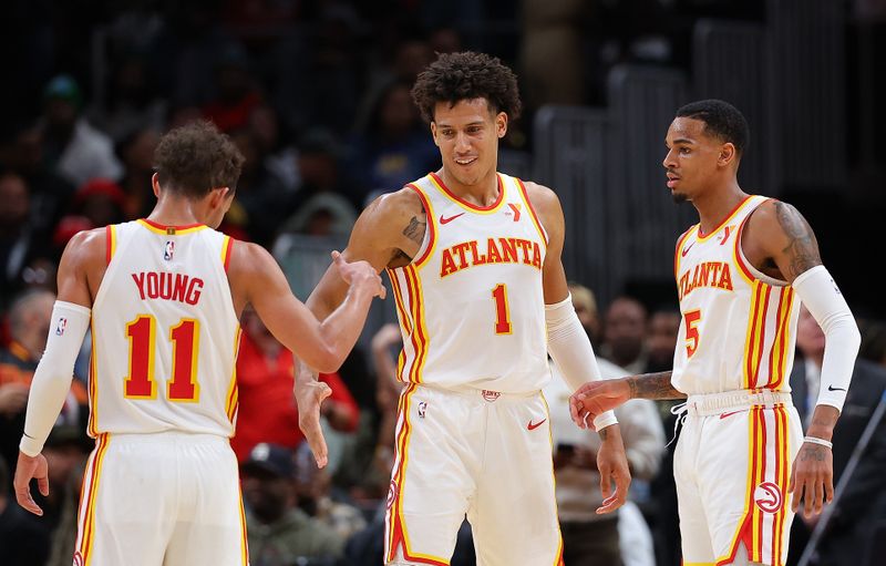 ATLANTA, GEORGIA - FEBRUARY 03:  Jalen Johnson #1 of the Atlanta Hawks reacts with Trae Young #11 and Dejounte Murray #5 after drawing a foul on a basket against the Golden State Warriors during overtime at State Farm Arena on February 03, 2024 in Atlanta, Georgia.  NOTE TO USER: User expressly acknowledges and agrees that, by downloading and/or using this photograph, user is consenting to the terms and conditions of the Getty Images License Agreement.  (Photo by Kevin C. Cox/Getty Images)