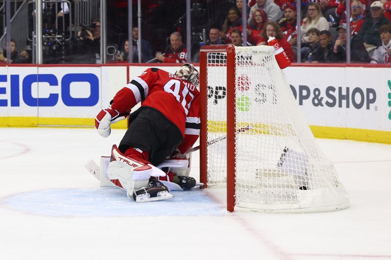 Oct 13, 2023; Newark, New Jersey, USA; Arizona Coyotes center Nick Schmaltz (8) (not shown) scores a goal on New Jersey Devils goaltender Akira Schmid (40) during the third period at Prudential Center. Mandatory Credit: Ed Mulholland-USA TODAY Sports