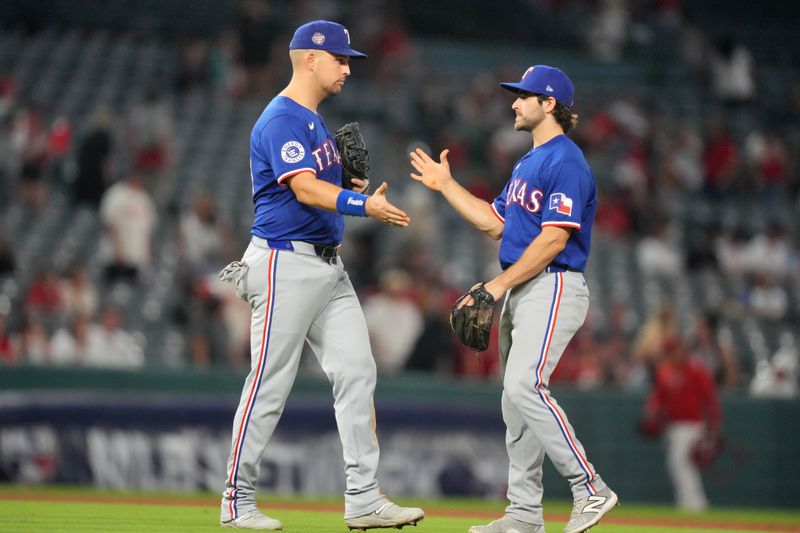 May 6, 2023; Anaheim, California, USA; Texas Rangers third baseman Josh Smith (8) and first baseman Nathaniel Lowe (30) celebrate at the end of the game against the Los Angeles Angels at Angel Stadium. Mandatory Credit: Kirby Lee-USA TODAY Sports